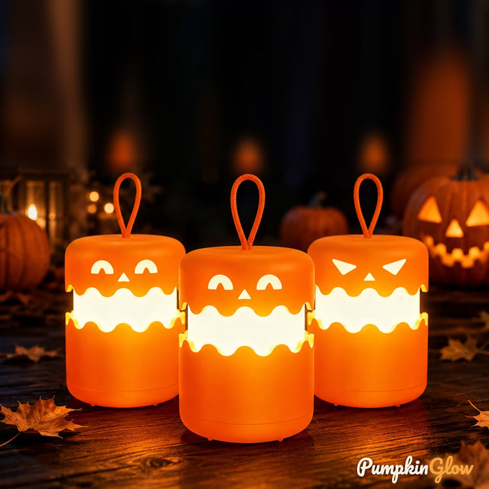 Three glowing PumpkinGlow lanterns with hanging loops